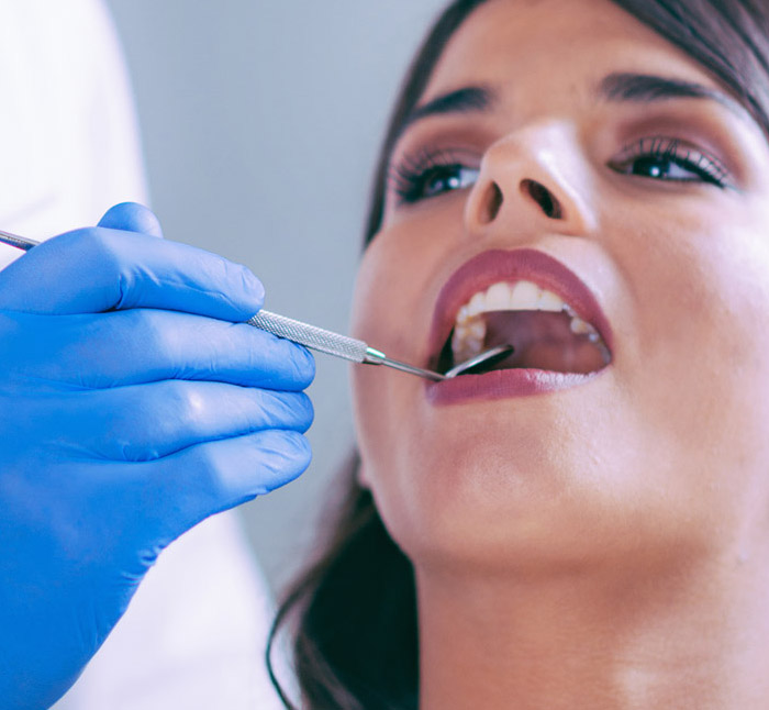 Close up view of young adult woman that have a visit in the dentist clinic. Conception of stomatology