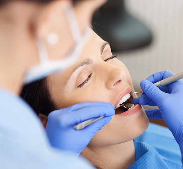 Close up view of young adult woman that have a visit in the dentist clinic. Conception of stomatology